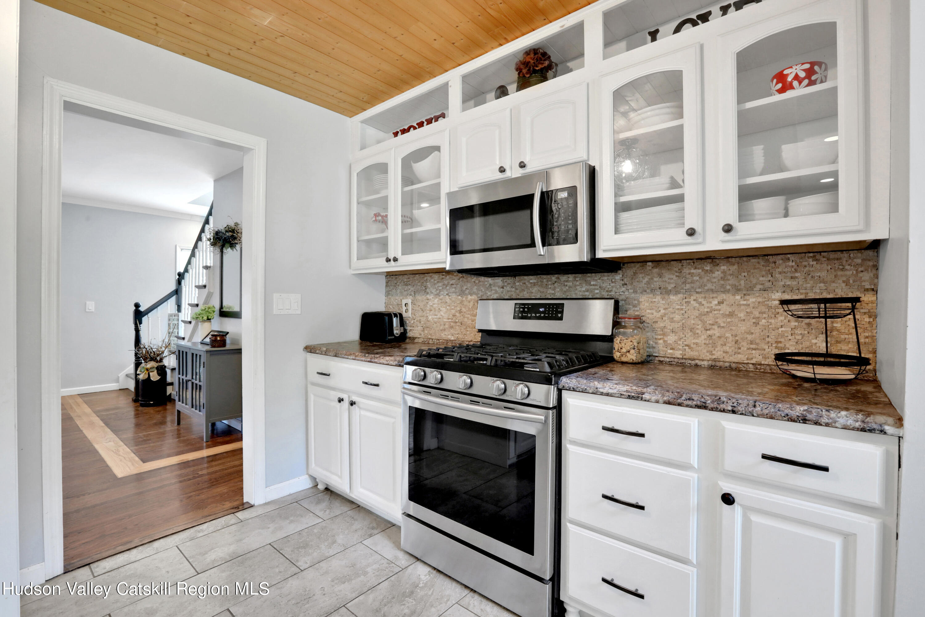 187 Russell Road Hurley, NY 12443 - Photo 9 of 33 a kitchen with stainless steel appliances granite countertop a stove and cabinets