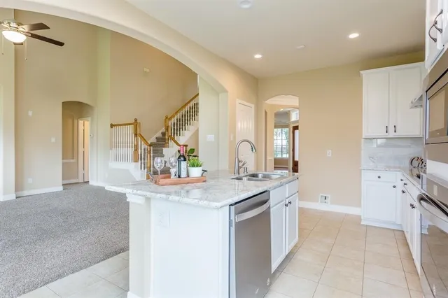 a bathroom with a granite countertop sink a toilet and mirror