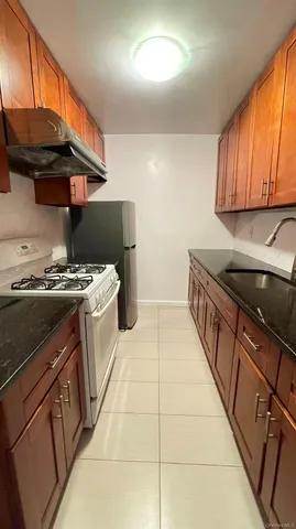 a kitchen with a sink a stove and a cabinets