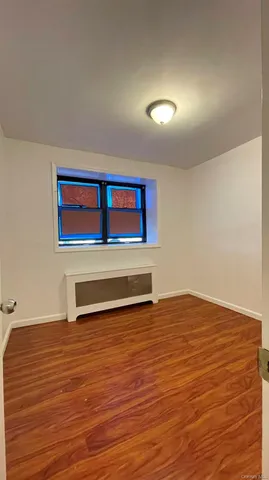 a view of a room with wooden floor