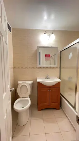 a bathroom with a bathtub sink mirror and toilet