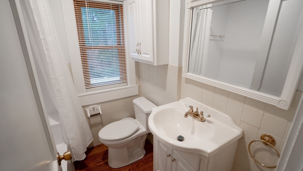 42 Amherst Road South Hadley, MA 01075 - Photo 15 of 28 a bathroom with a toilet a sink and a window