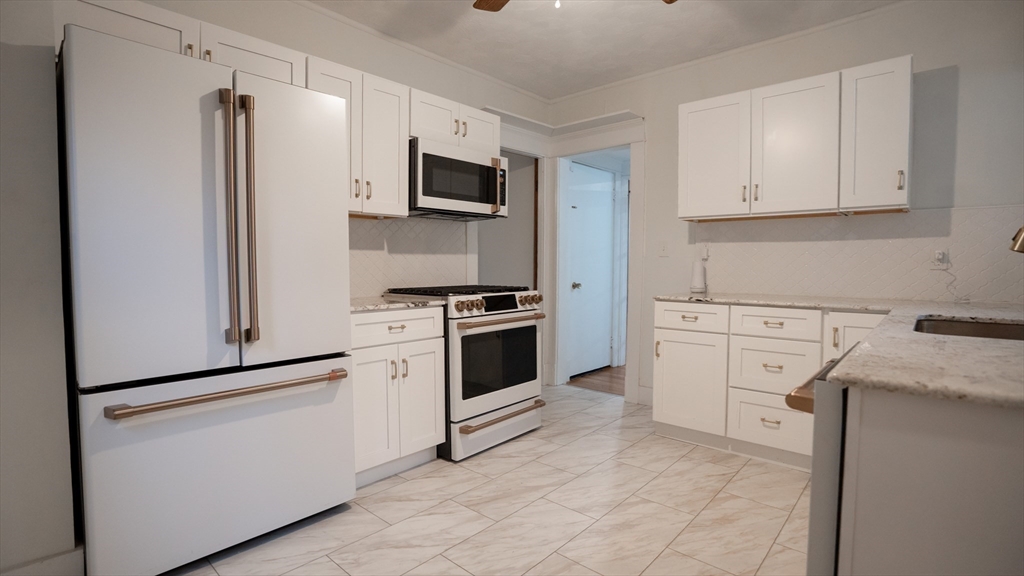 42 Amherst Road South Hadley, MA 01075 - Photo 4 of 28 a kitchen with white cabinets and white appliances