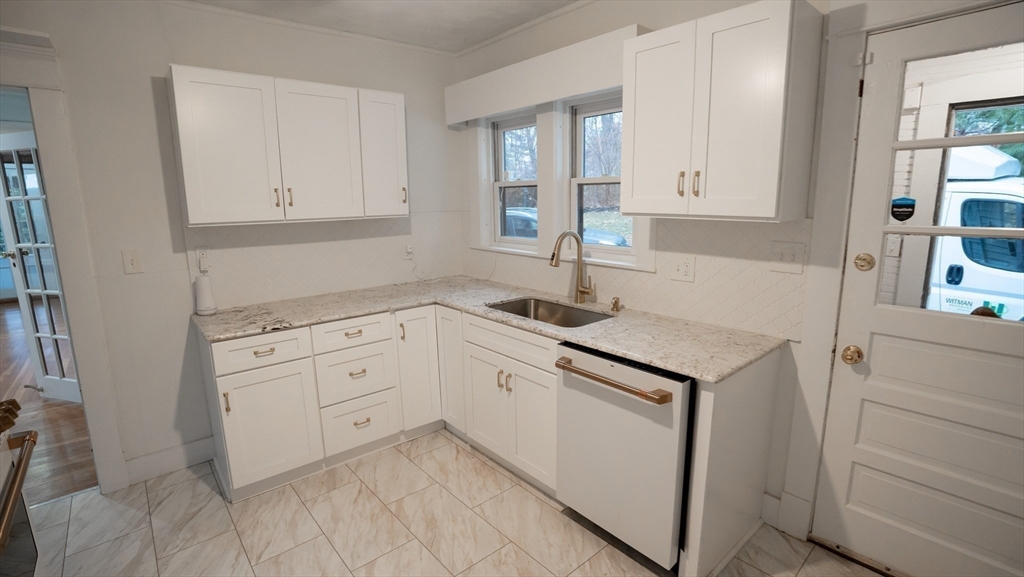 42 Amherst Road South Hadley, MA 01075 - Photo 5 of 28 a kitchen with white cabinets and sink