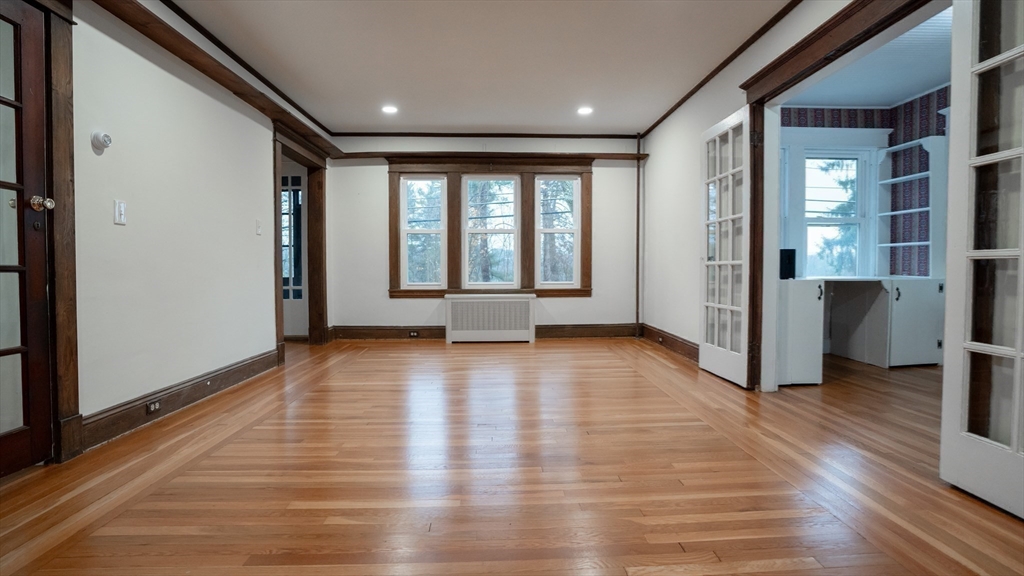 42 Amherst Road South Hadley, MA 01075 - Photo 9 of 28 a view of an empty room with wooden floor and a window