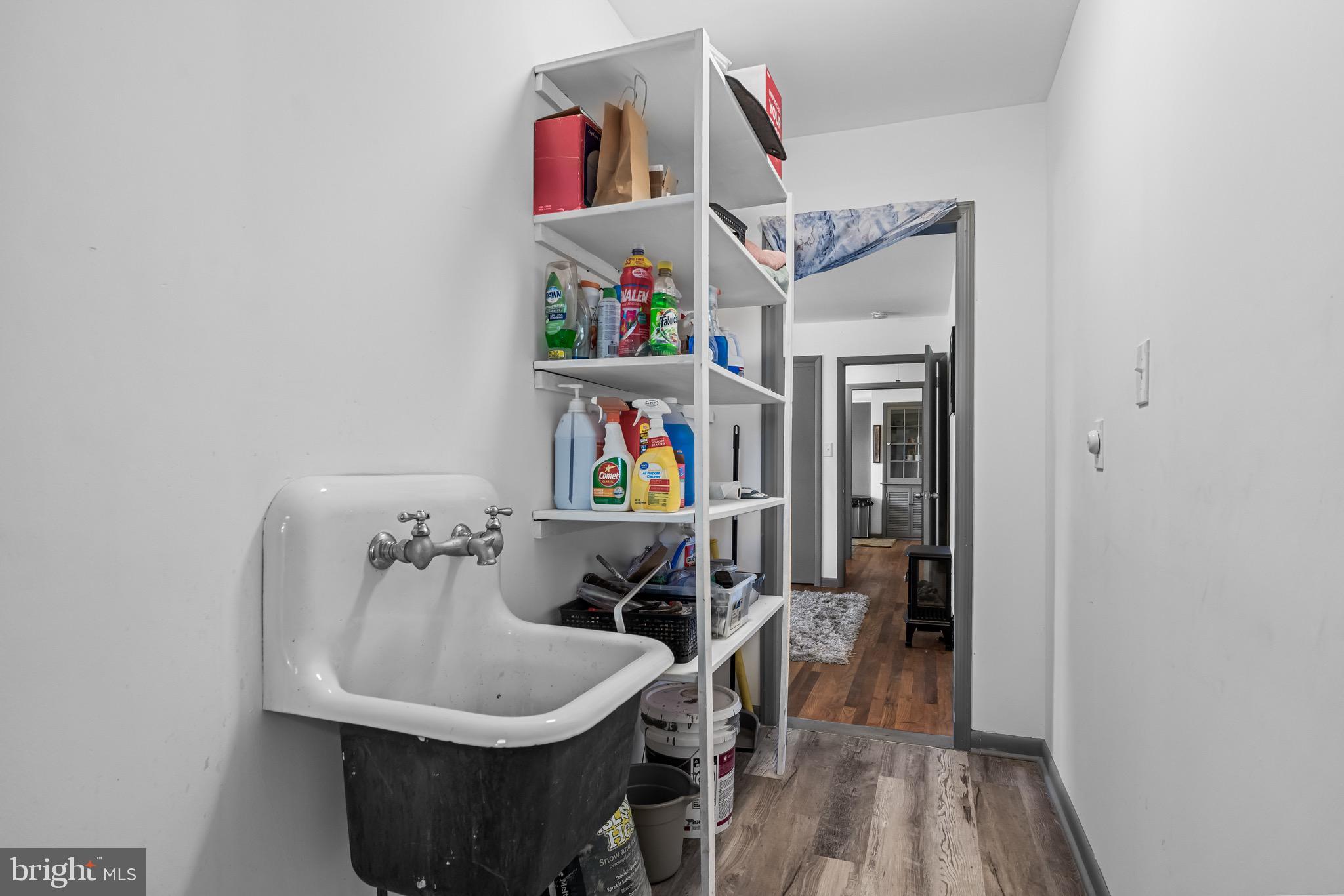 147 New Union Street Salem, NJ 08079 - Photo 15 of 28 a utility room with lots of clutter and cabinets