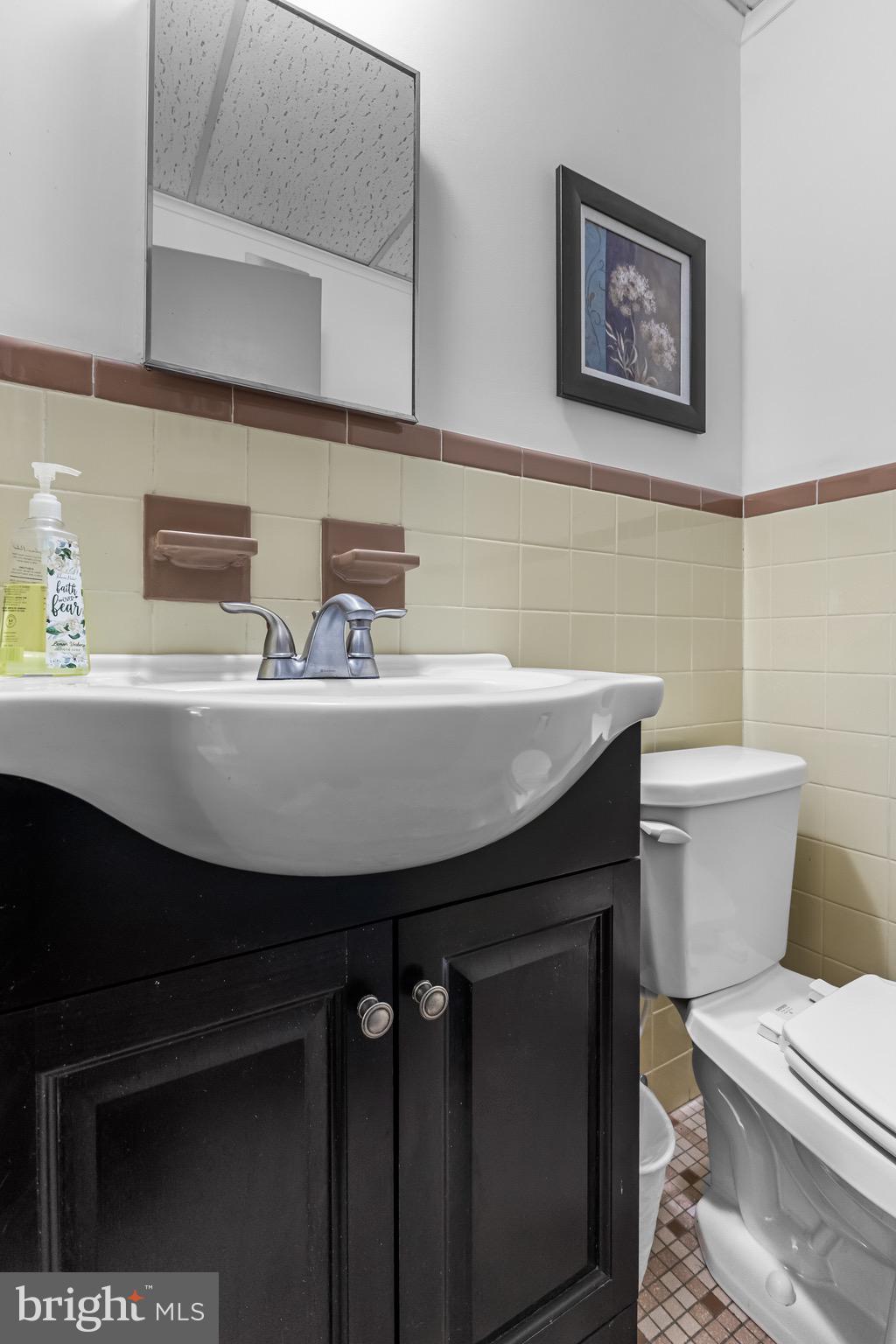 147 New Union Street Salem, NJ 08079 - Photo 20 of 28 a bathroom with a sink a toilet a mirror and vanity