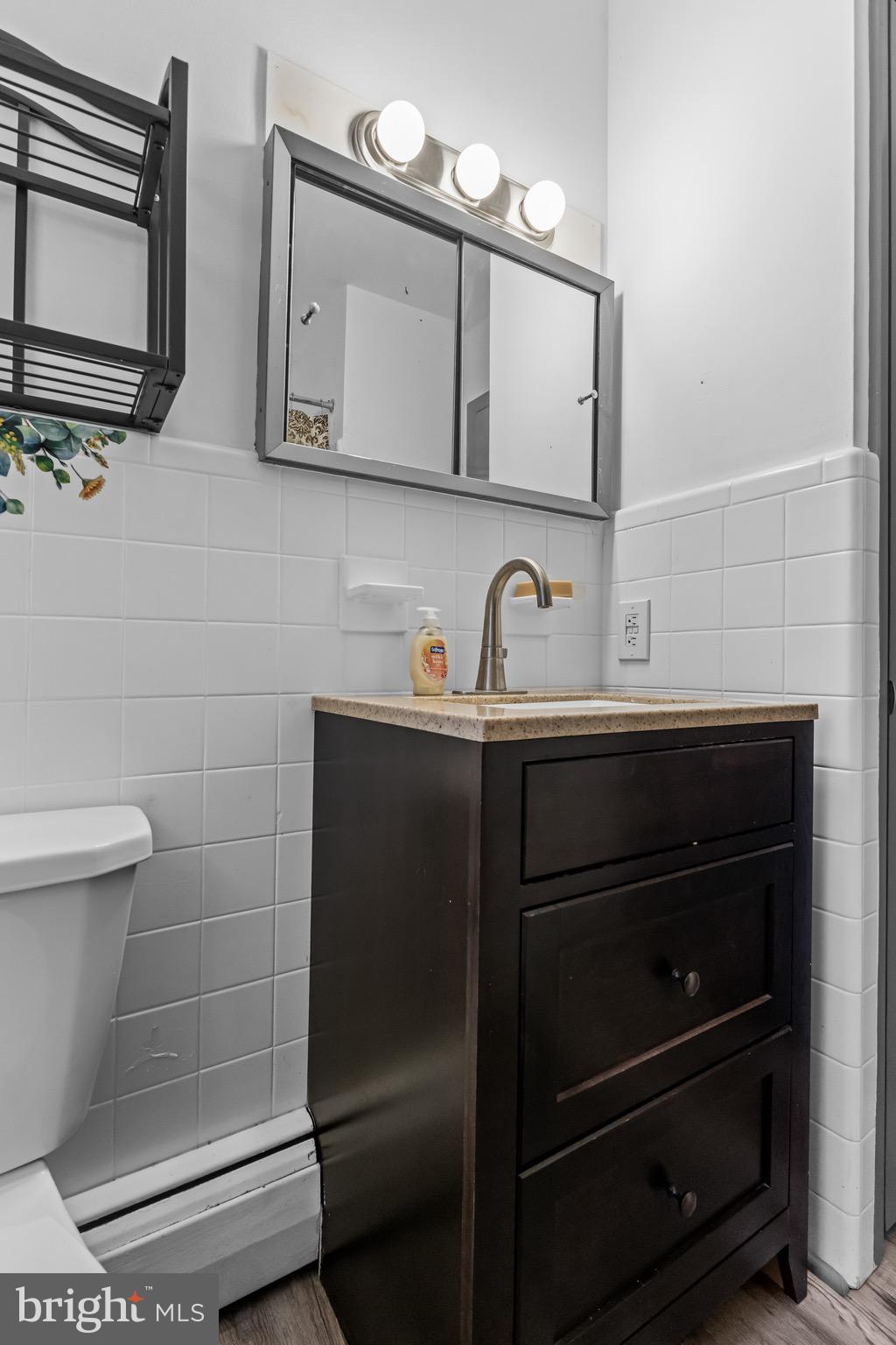 147 New Union Street Salem, NJ 08079 - Photo 10 of 28 a bathroom with a sink a toilet and mirror