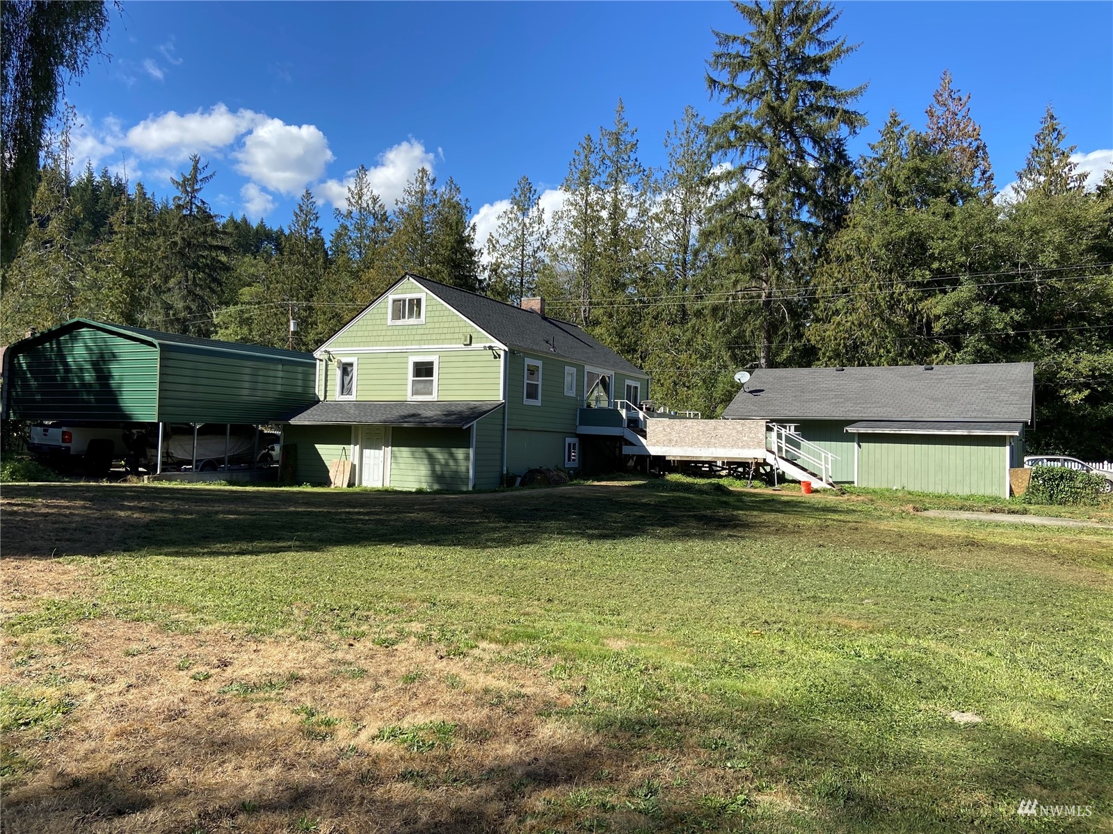 4191 Kitsap Lake Road Northwest Bremerton, WA 98312 - Photo 15 of 17 a front view of a house with a garden and swimming pool