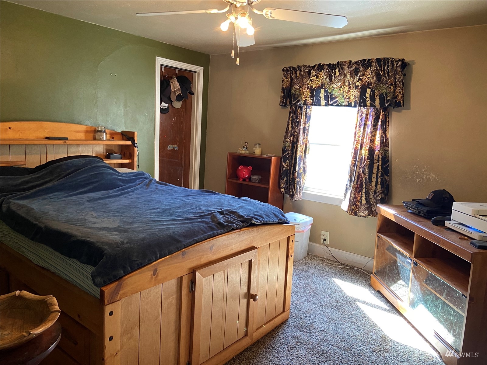 4191 Kitsap Lake Road Northwest Bremerton, WA 98312 - Photo 7 of 17 a bedroom with a bed and a chandelier