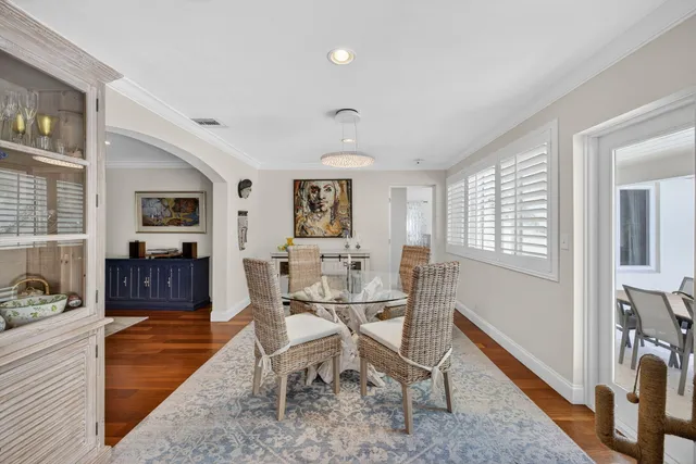 a kitchen with cabinets stainless steel appliances a sink and wooden floor