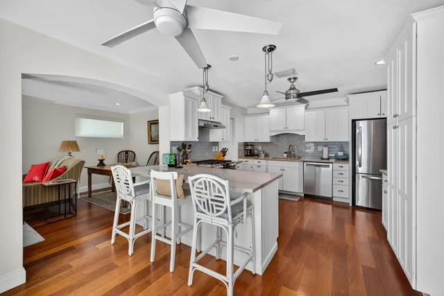 a kitchen with stainless steel appliances granite countertop a sink and cabinets