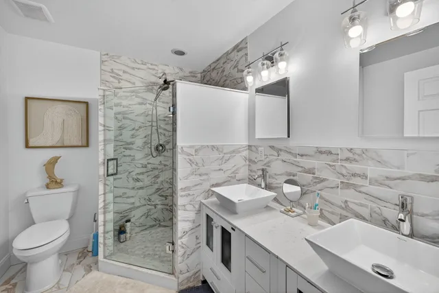 a bathroom with a sink toilet and shower