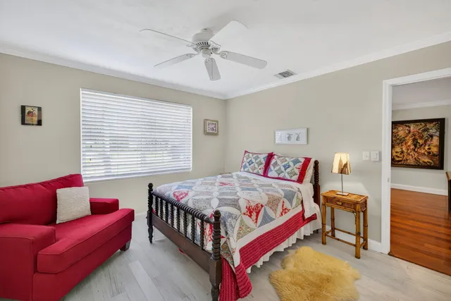 a bed sitting in a room next to a window