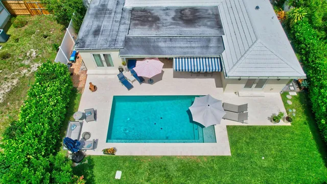 a view of house with swimming pool and porch