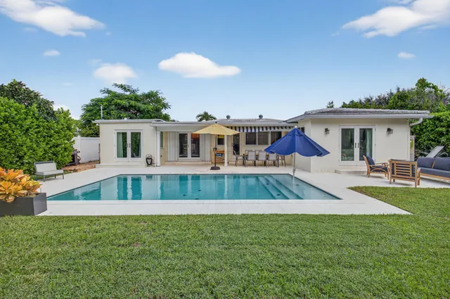 a view of backyard with large trees and plants