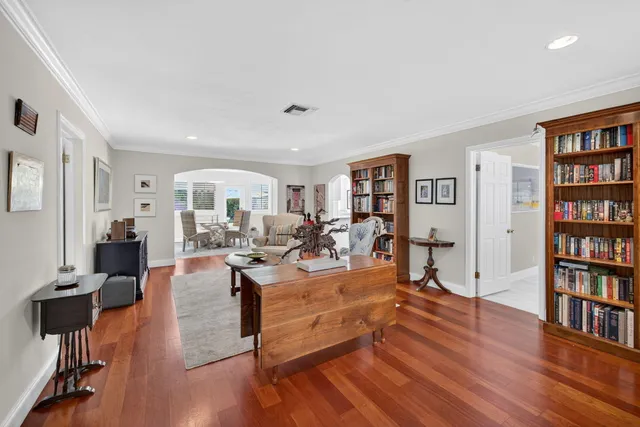 a living room with furniture a coffee table and a bookshelf