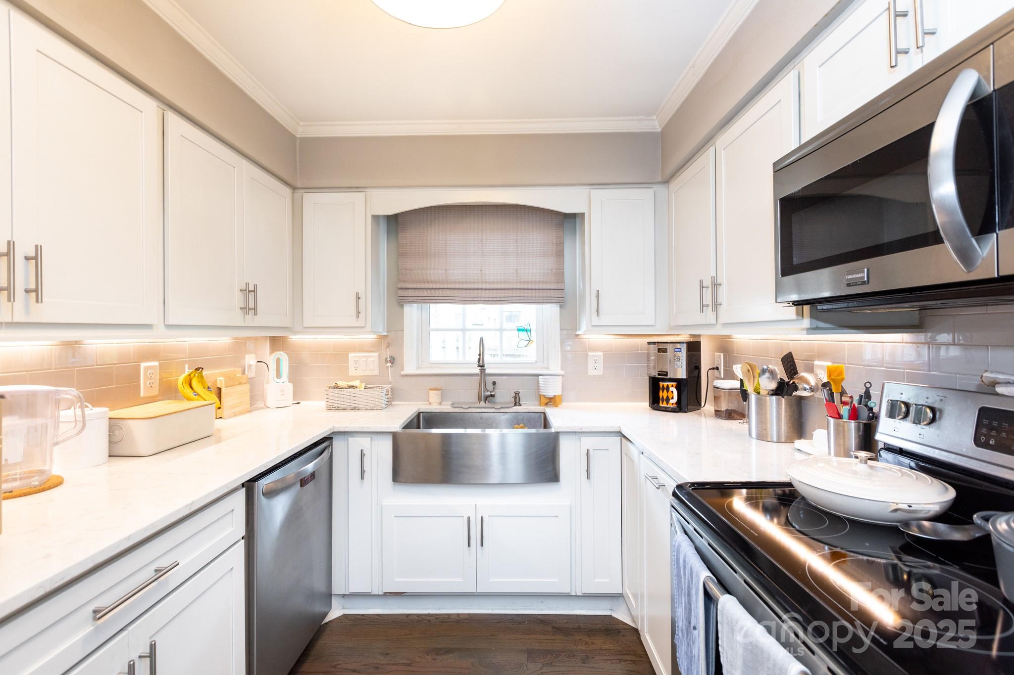 2229 Rexford Road, Unit E Charlotte, NC 28211 - Photo 11 of 28 a kitchen with a sink a stove and microwave