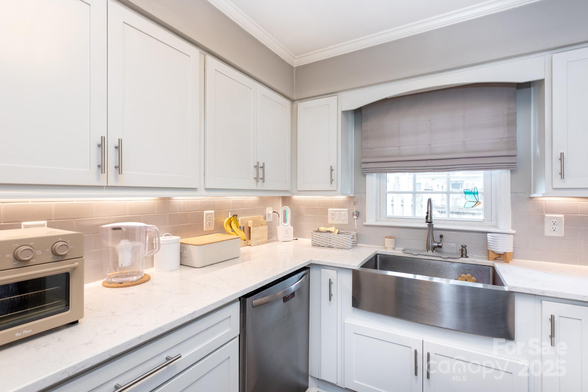 2229 Rexford Road, Unit E Charlotte, NC 28211 - Photo 13 of 28 a kitchen with kitchen island granite countertop a sink a stove and cabinets