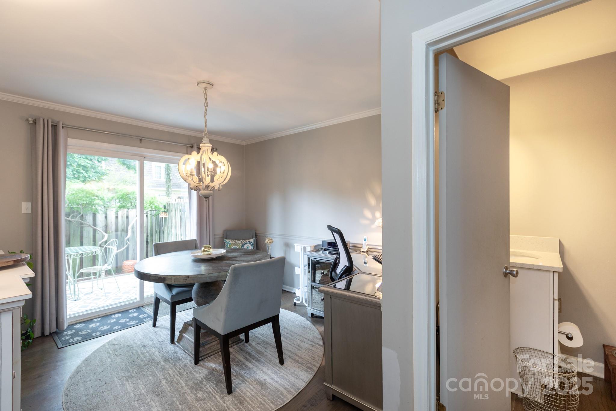 2229 Rexford Road, Unit E Charlotte, NC 28211 - Photo 15 of 28 a dining room with furniture a chandelier and window