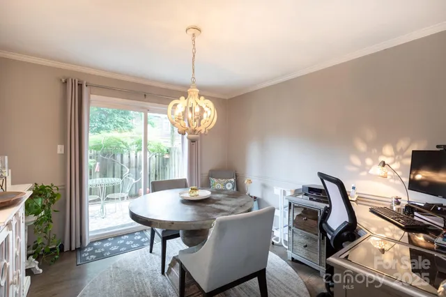 a view of a dining room with furniture wooden floor and chandelier