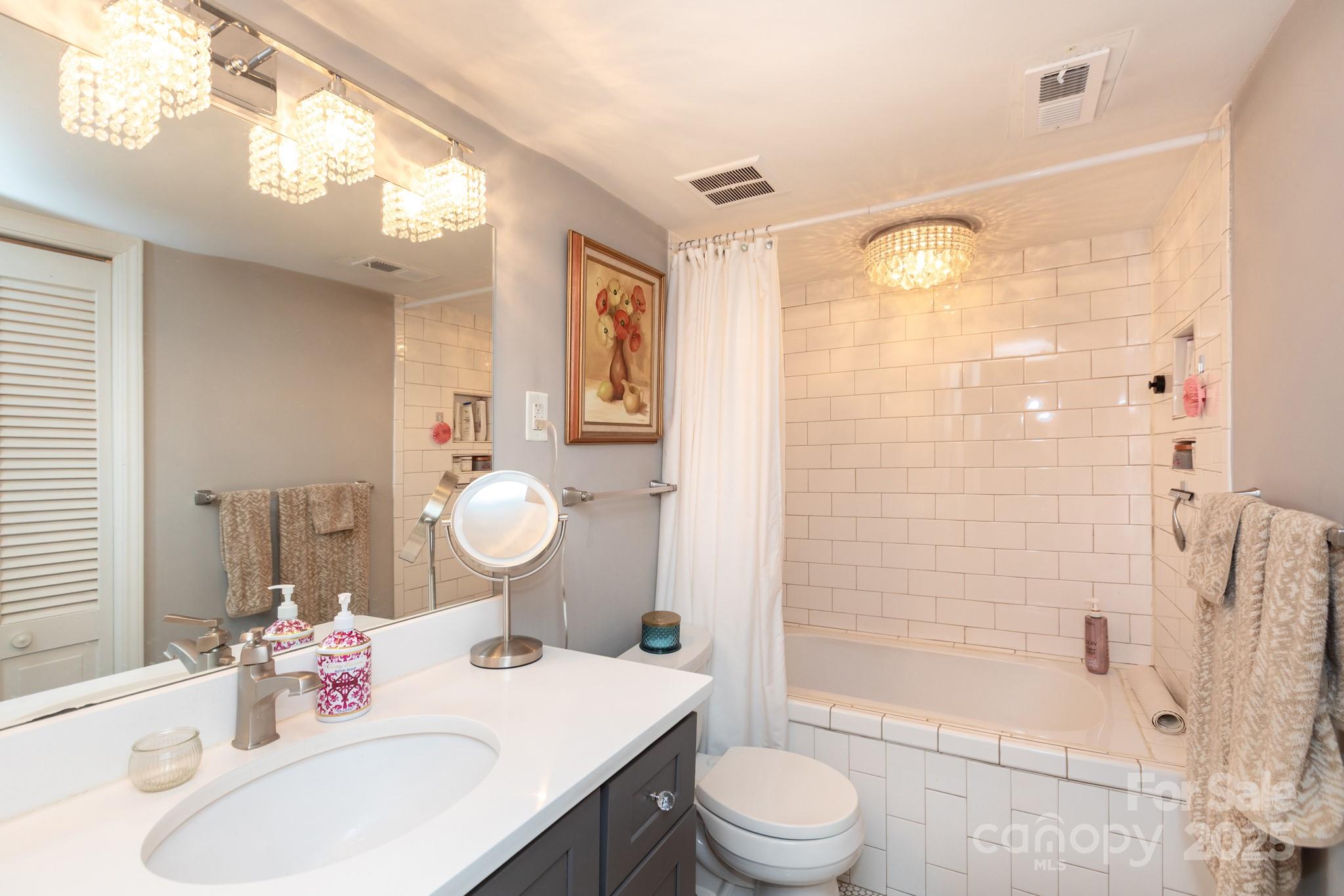 2229 Rexford Road, Unit E Charlotte, NC 28211 - Photo 22 of 28 a bathroom with a sink toilet and shower
