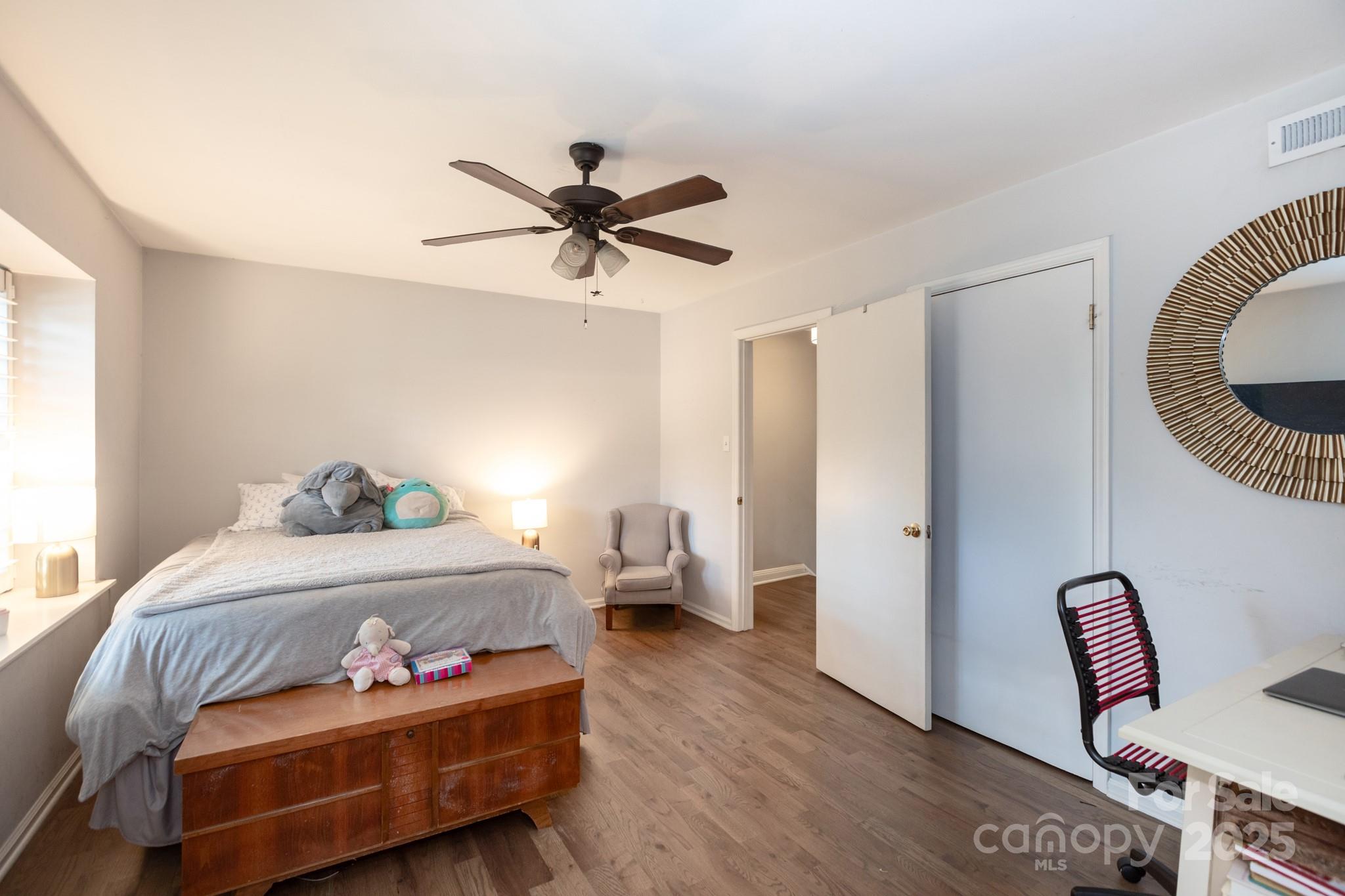 2229 Rexford Road, Unit E Charlotte, NC 28211 - Photo 23 of 28 a bedroom with a bed and wooden floor