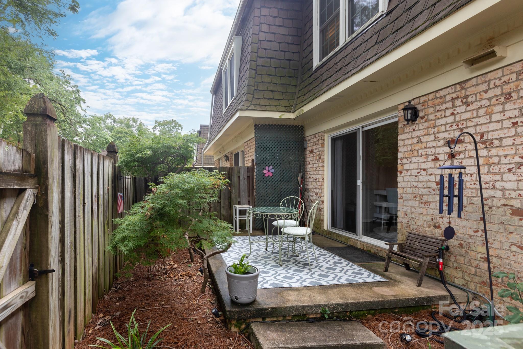 2229 Rexford Road, Unit E Charlotte, NC 28211 - Photo 26 of 28 a view of house with patio outdoor seating and covered with trees