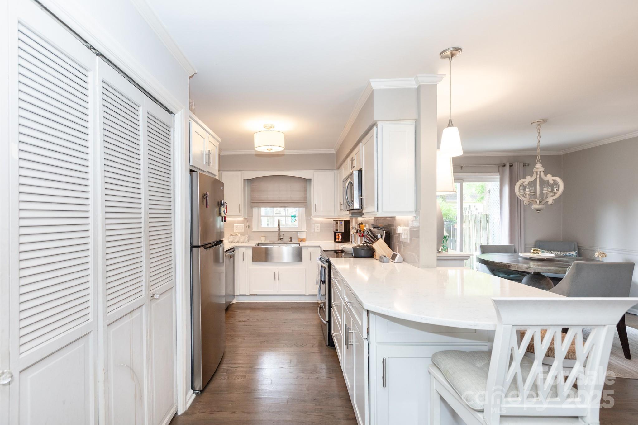 2229 Rexford Road, Unit E Charlotte, NC 28211 - Photo 10 of 28 a kitchen with sink refrigerator and window