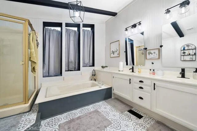 a bathroom with a double vanity sink mirror and shower