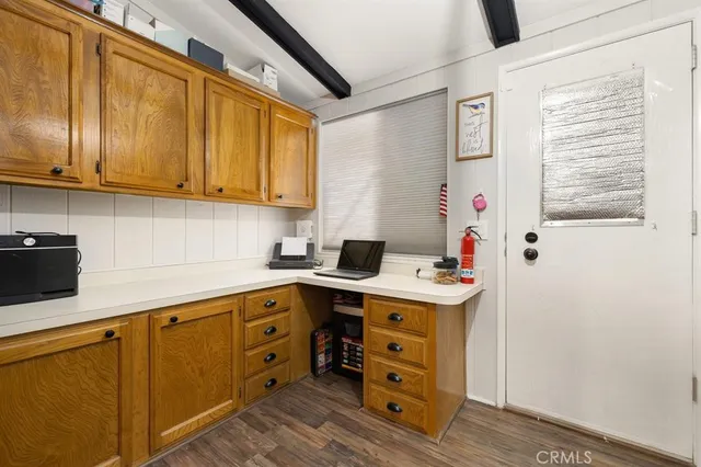 a kitchen with cabinets appliances and a window