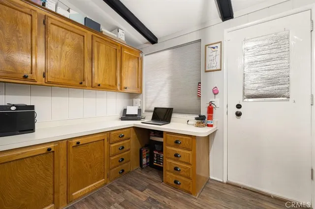 a kitchen with cabinets appliances and a window