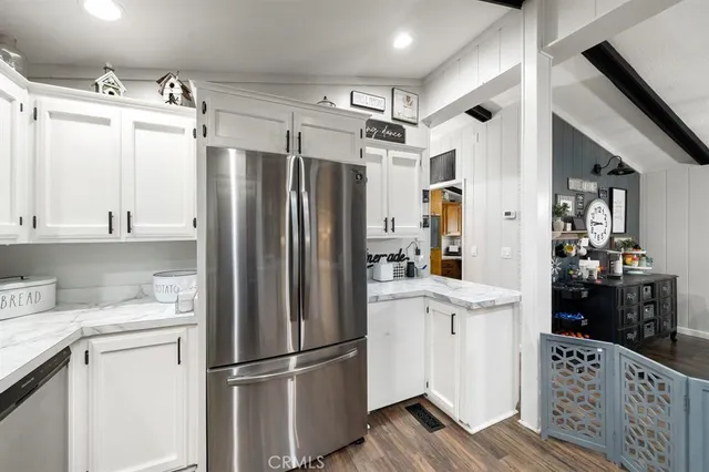 a kitchen with stainless steel appliances a refrigerator sink and cabinets