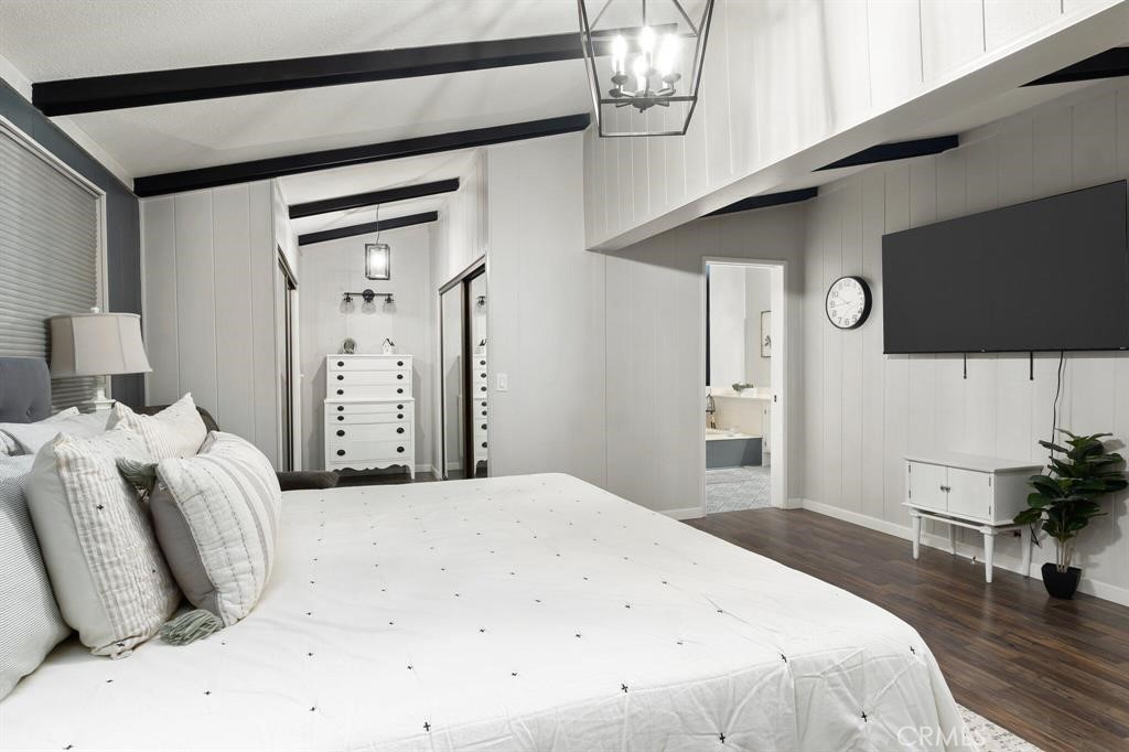 81641 Ave 48, Unit 88 Indio, CA 92201 - Photo 9 of 17 a bedroom with a bed and a flat screen tv