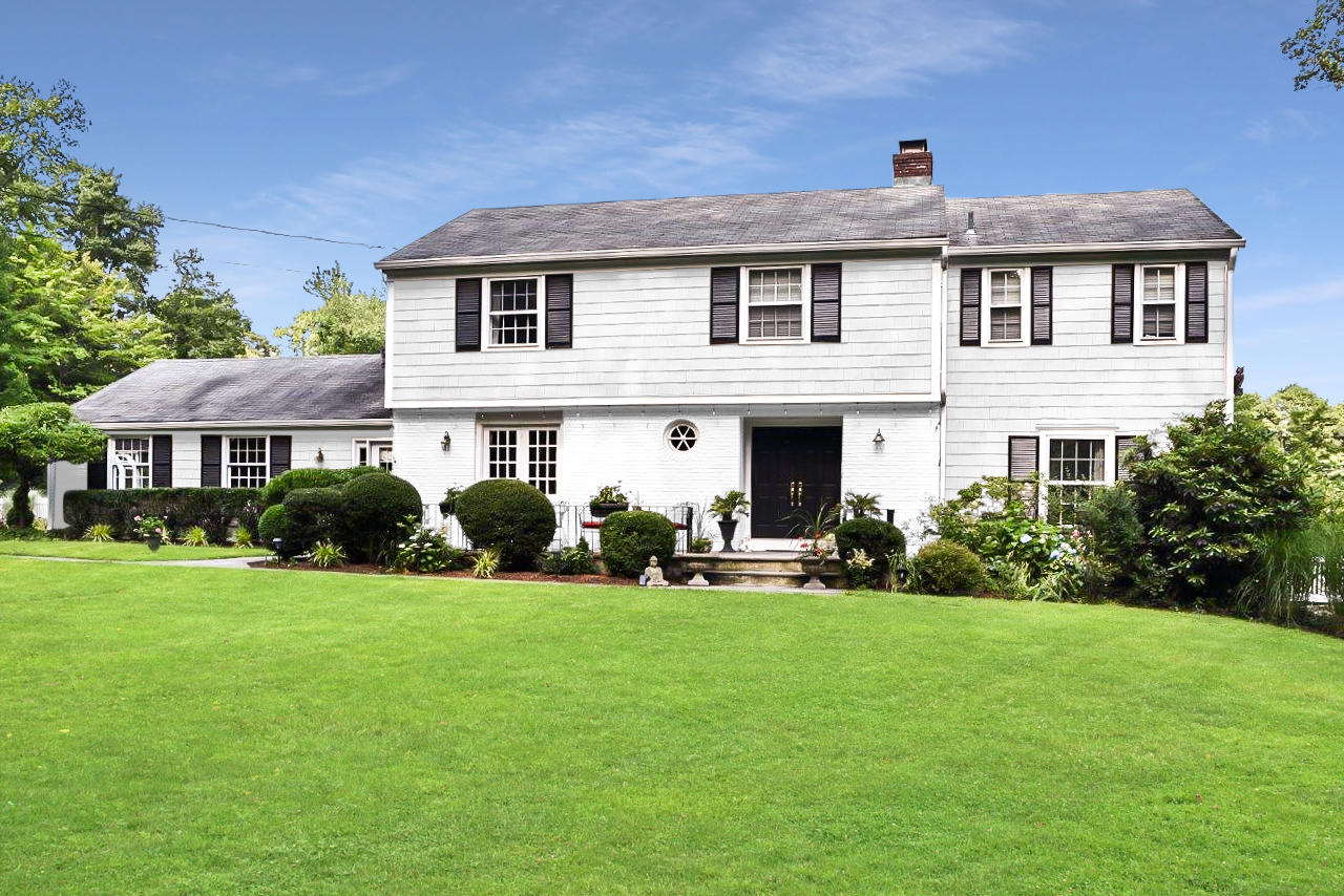 22 Country Club Road New Canaan, CT 06840 - Photo 1 of 47 a front view of a house with a garden
