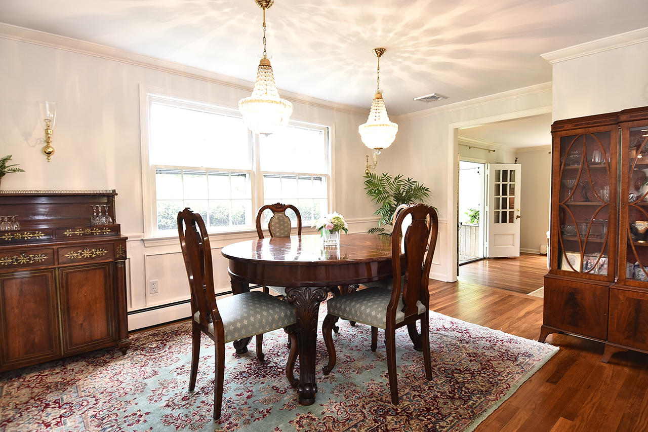 22 Country Club Road New Canaan, CT 06840 - Photo 16 of 47 a dining room with furniture a chandelier and wooden floor