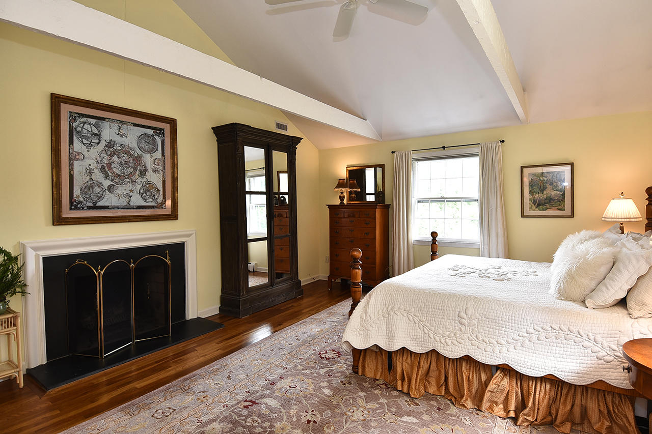 22 Country Club Road New Canaan, CT 06840 - Photo 26 of 47 a spacious bedroom with a bed and a dresser