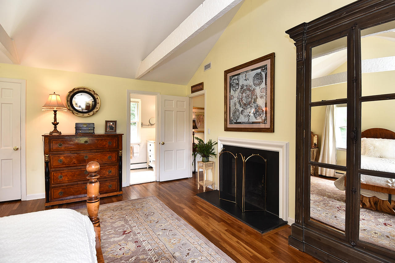 22 Country Club Road New Canaan, CT 06840 - Photo 27 of 47 a living room with furniture a fireplace and a large window