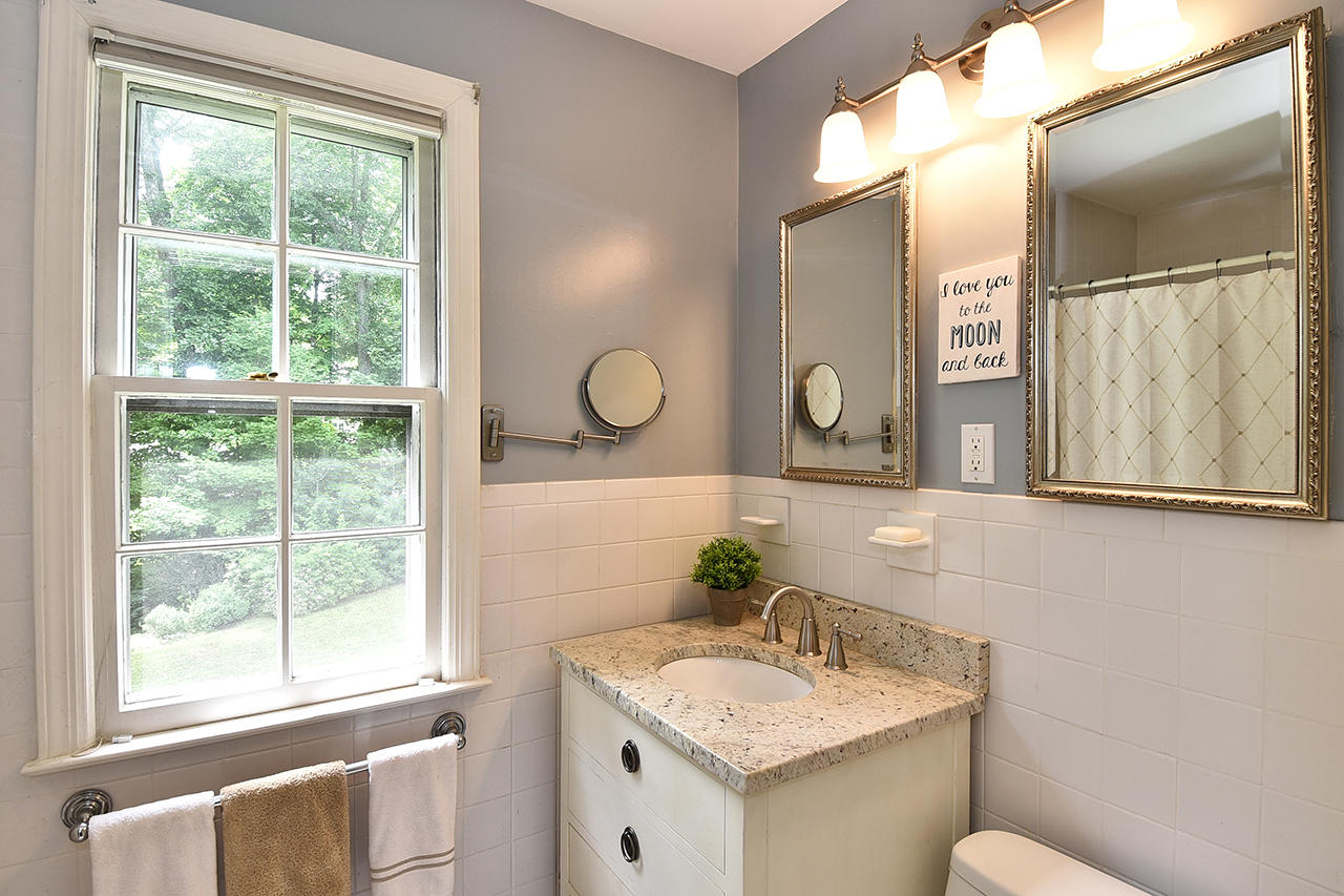 22 Country Club Road New Canaan, CT 06840 - Photo 28 of 47 a bathroom with a toilet sink and mirror