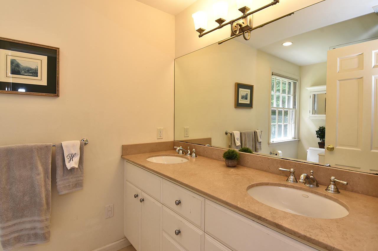 22 Country Club Road New Canaan, CT 06840 - Photo 31 of 47 a bathroom with a granite countertop sink and a mirror
