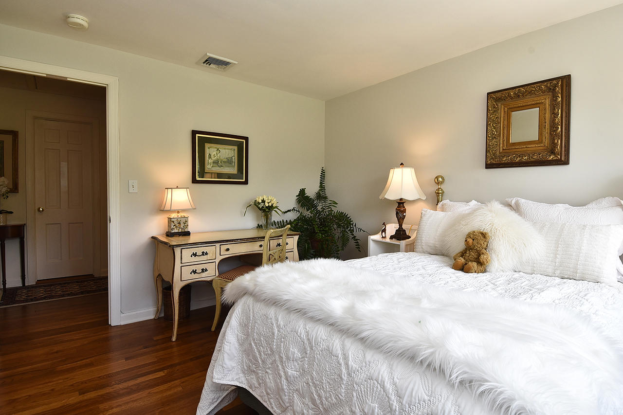 22 Country Club Road New Canaan, CT 06840 - Photo 34 of 47 a bedroom with a bed and wooden floor