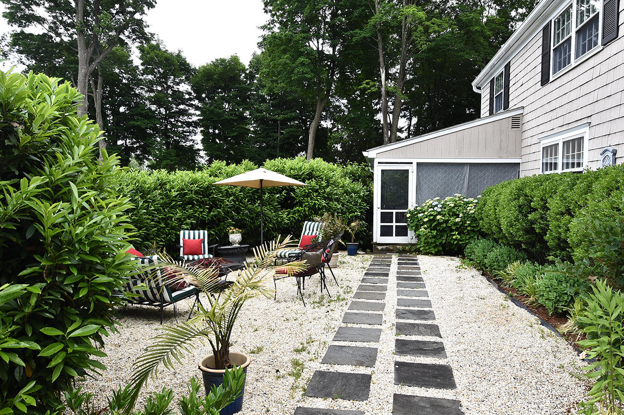 22 Country Club Road New Canaan, CT 06840 - Photo 43 of 47 a view of a backyard with sitting area and furniture