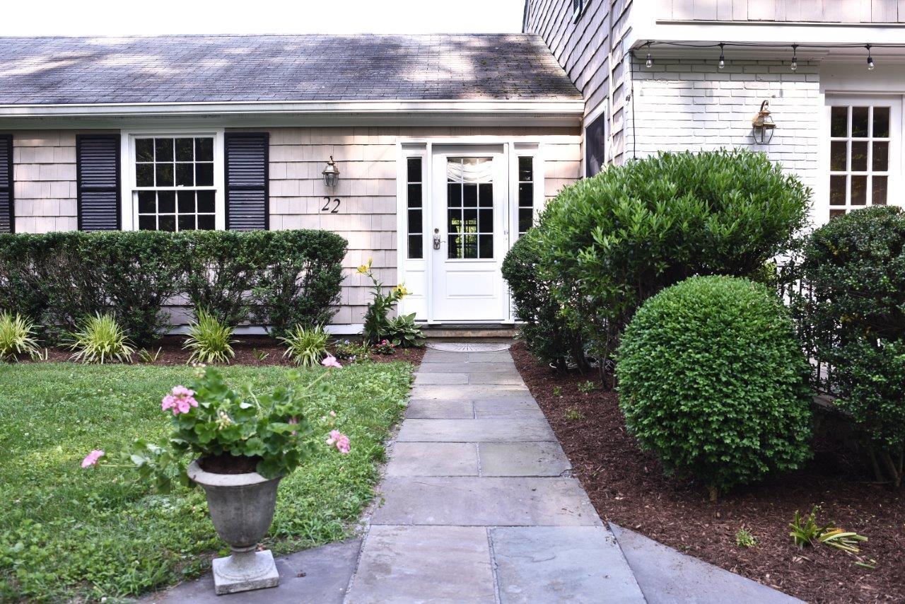22 Country Club Road New Canaan, CT 06840 - Photo 44 of 47 a front view of a house with a garden