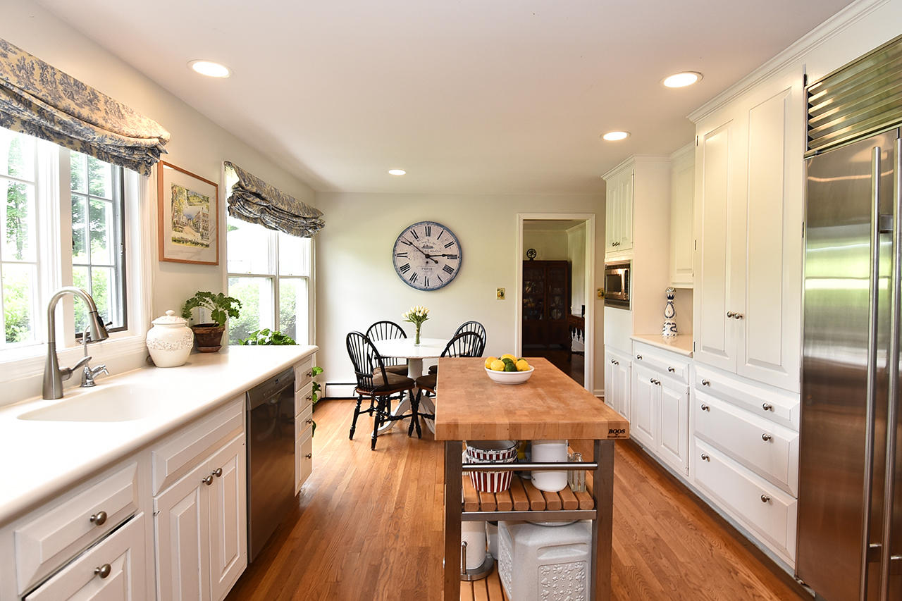 22 Country Club Road New Canaan, CT 06840 - Photo 9 of 47 a kitchen with stainless steel appliances granite countertop a refrigerator a stove and white cabinets with wooden floor