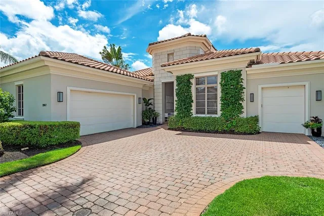 a view of a house with a yard and potted plants