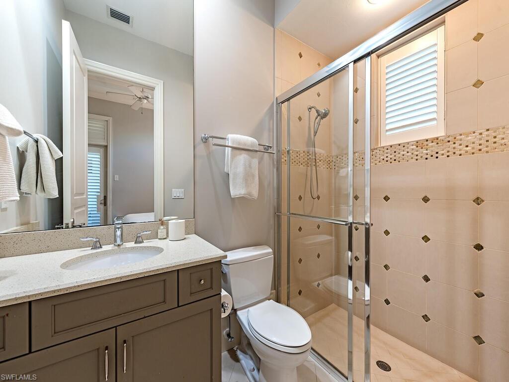 2087 Rivoli Court Naples, FL 34105 - Photo 12 of 37 a bathroom with a sink a toilet and shower