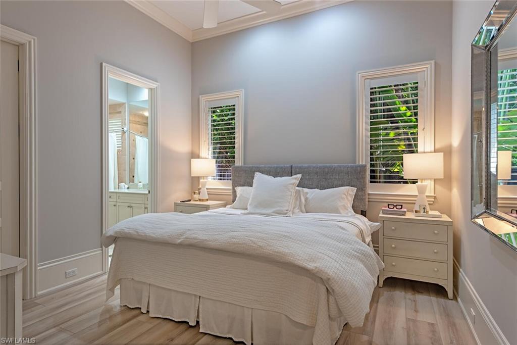 2087 Rivoli Court Naples, FL 34105 - Photo 13 of 37 a bedroom with a bed and a window