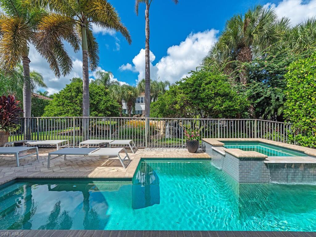 2087 Rivoli Court Naples, FL 34105 - Photo 16 of 37 a view of a chair and tables in the backyard