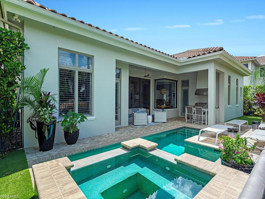2087 Rivoli Court Naples, FL 34105 - Photo 17 of 37 a front view of a house with garden