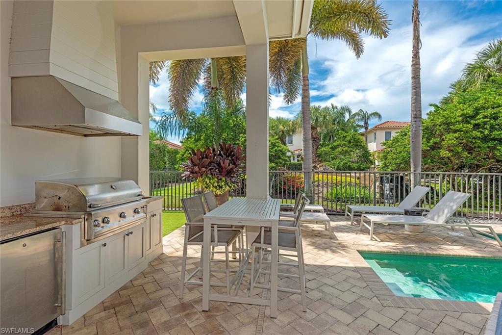 2087 Rivoli Court Naples, FL 34105 - Photo 20 of 37 a balcony with furniture and a garden